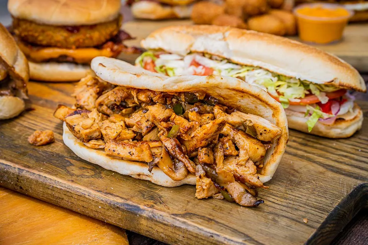 Loaded chicken sandwich on a wooden board